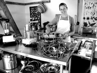 Pay Dirt Farm School Apprentice Mick DeLamarter perfects a garlic scape 
recipe in the new experimental kitchen open to the public at MaryJanesFarm, 
Moscow, Idaho. 